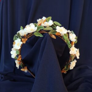 Bridal jeweled headband with white flowers, dark green and gold leaves, handcrafted in cold porcelain with crystal details and silk thread wrapping.