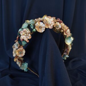 Handmade floral headband featuring metallic red and blue flowers sculpted from cold porcelain.