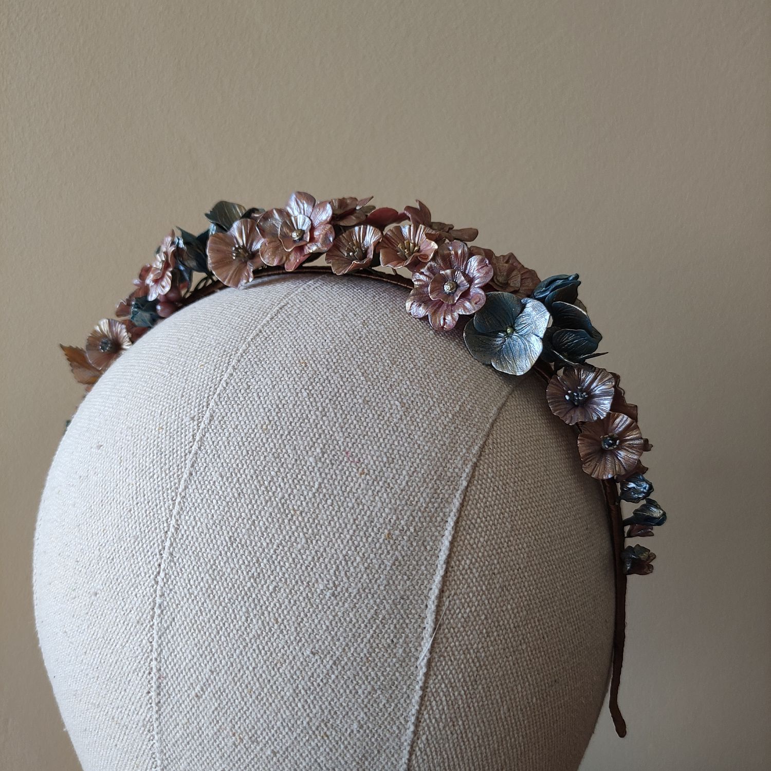 Fantasy flower headband with metallic red and blue blooms complemented by elegant golden leaves.